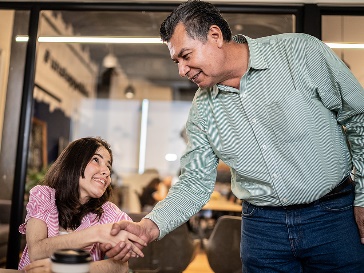 A person shaking hands with another person.