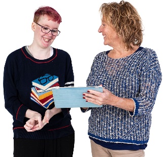 A person supporting someone to read a document.